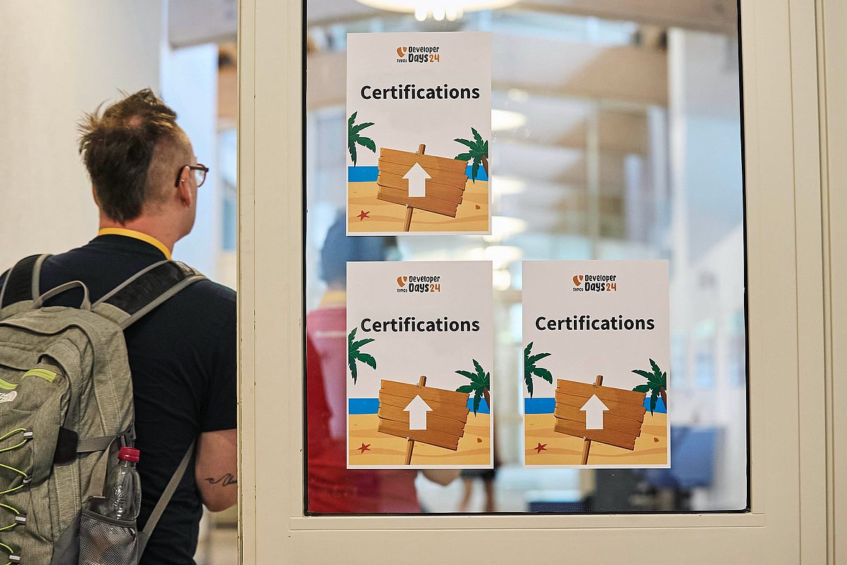 Man entering a door marked with "certification" signs.