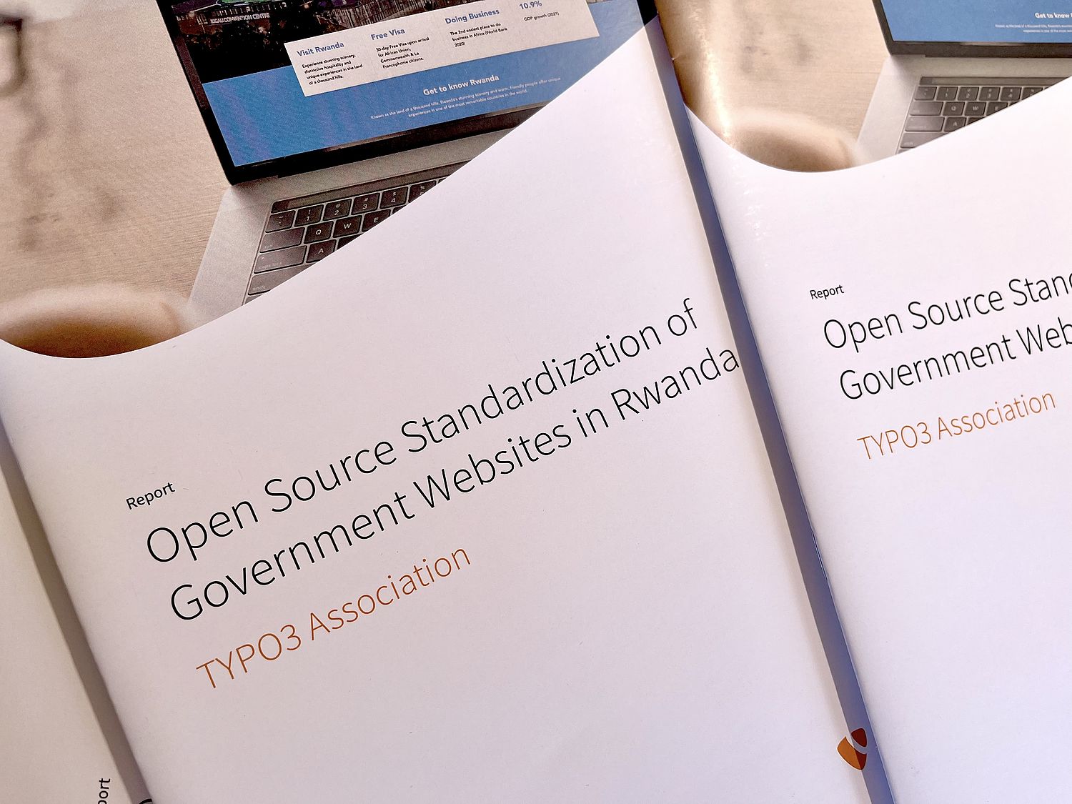 Photo of printed reports on "Open Source Standardization of Government Websites in Rwanda".