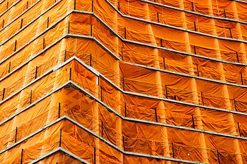 Orange scaffolding on building.