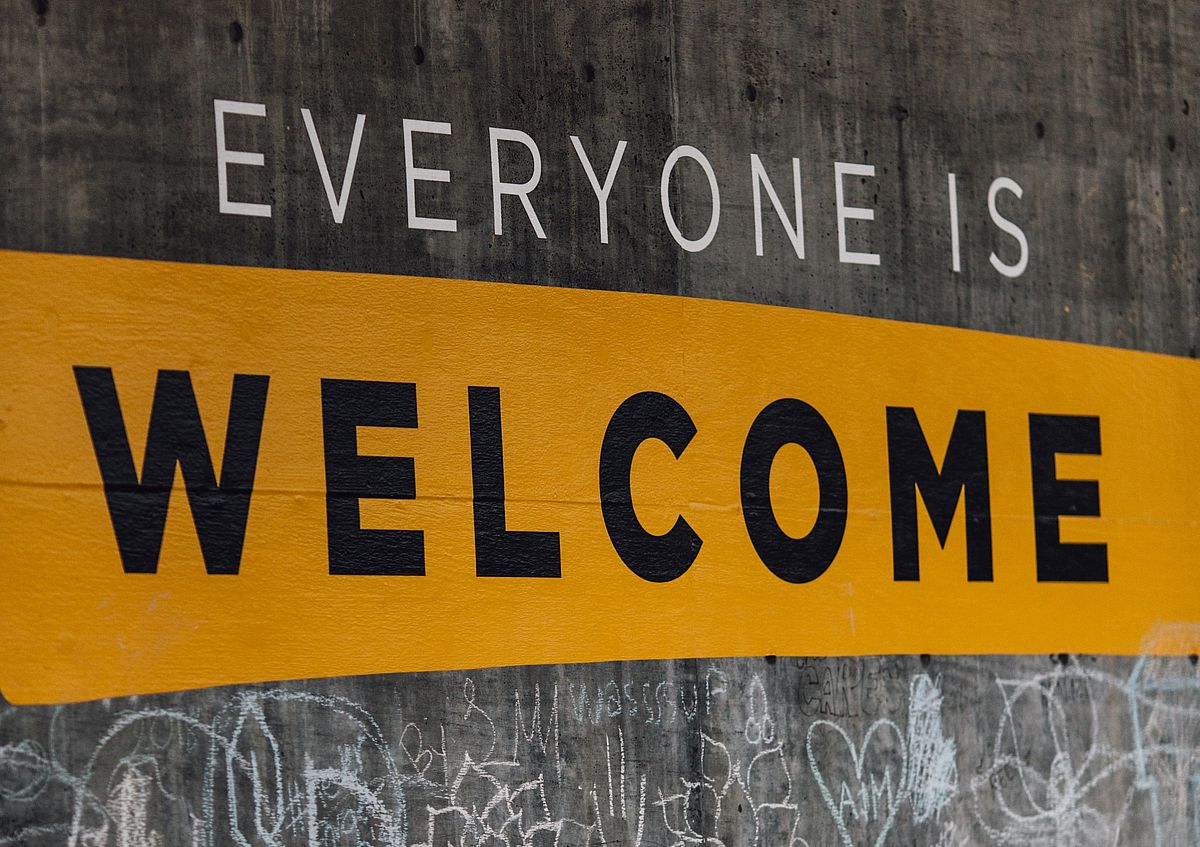 "Everyone is Welcome" painted on a wall.