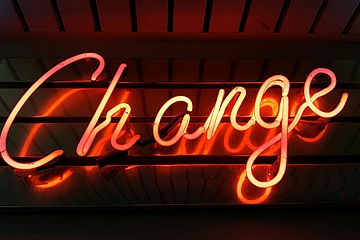 The word "Change" in illuminated orange letters on a black background.