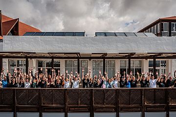 Group photo of TYPO3 Surfcamp attendees on the balcony of the venue in Fuerteventura.