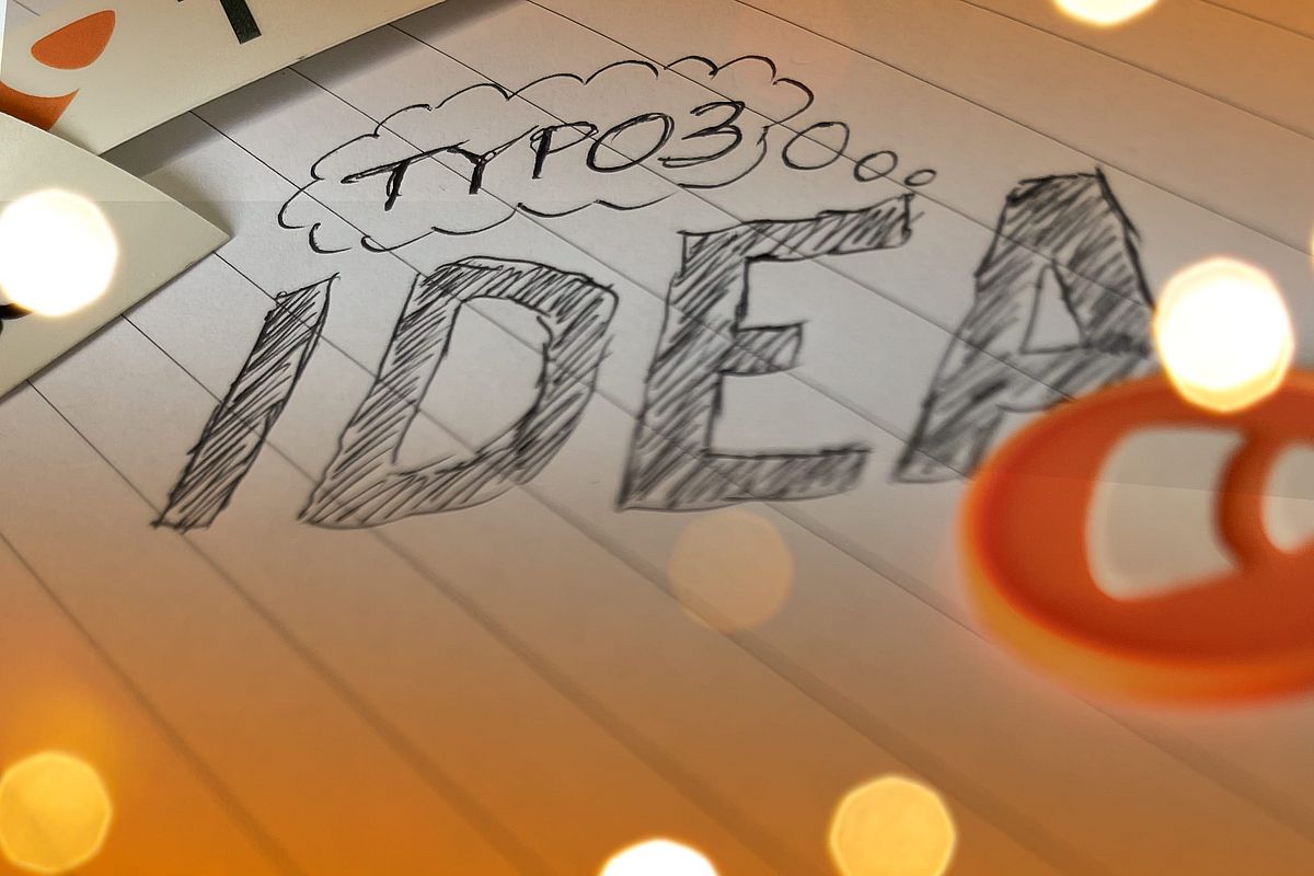 The text "TYPO3 idea" hand-drawn on line paper surrounded by TYPO3 logo and orange colors.