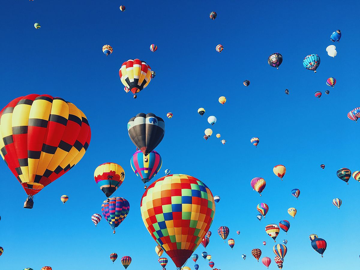 Blue sky full of colorful hot-air balloons