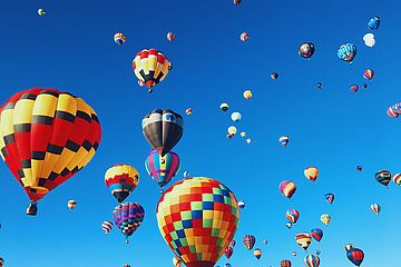Blue sky full of colorful hot-air balloons