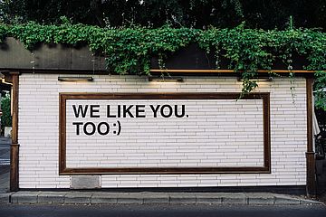 "We like you too" written on a wall in all caps.