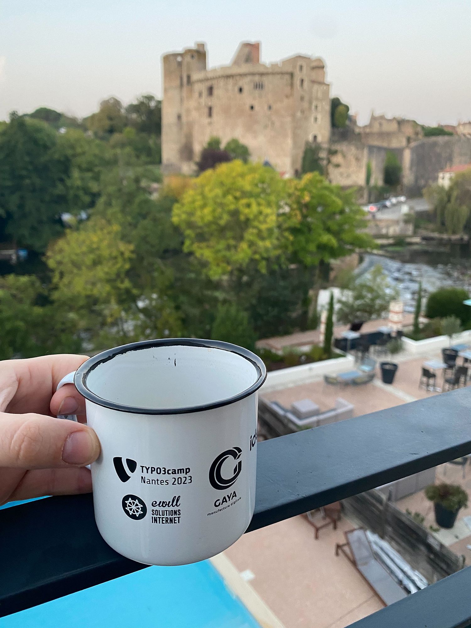View of a balcony with a TYPO3 Camp Nantes cup in the foreground.