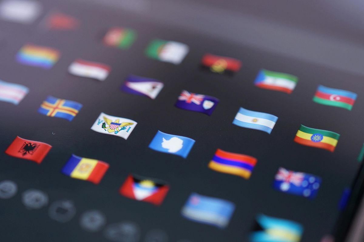 A close-up of a digital screen displaying various small, colorful international flags, all arranged in a grid on a dark background.