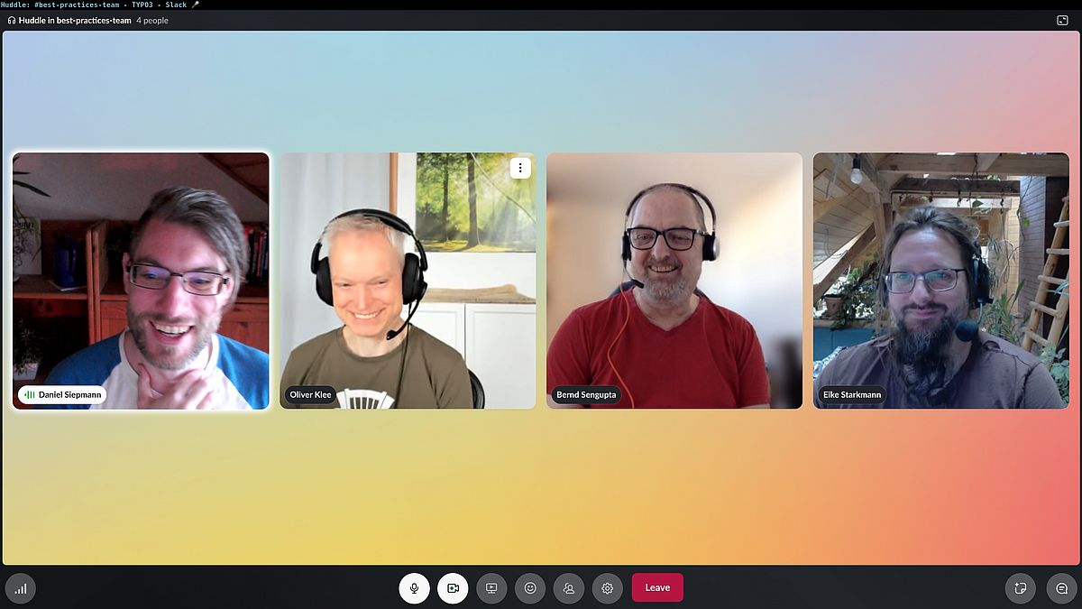 Four people are participating in a video call, each smiling and wearing headsets. Their names are displayed: Daniel, Oliver, Bernd, and Eike. The background of the call screen is a soft gradient of pastel colors.