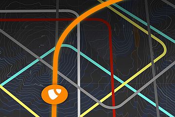 A stylized map with colorful intersecting lines on a dark background, resembling a car's first-person navigation interface. An orange line is highligted and has a round icon with the TYPO3 logo towards the bottom. Other street-like lines in fainter colors, as well as topographic lines, are visible in the background.