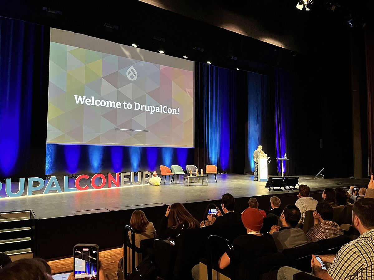 Stage with projection screen showing the text "Welcome to DrupalCon"